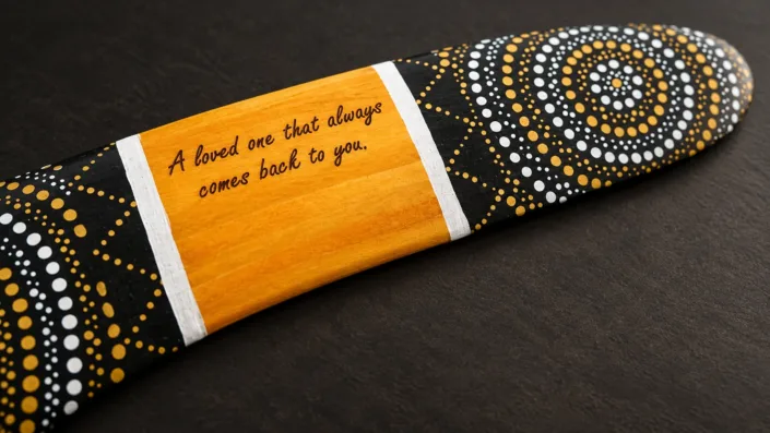 Dark engraved personal message — illustration Illustration of a personal message engraved on the amber panel of a Golden Sun boomerang.