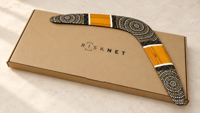 Wooden boomerang on a branded kraft box — illustration Illustration of a Golden Sun boomerang on a kraft gift box with a company wordmark.