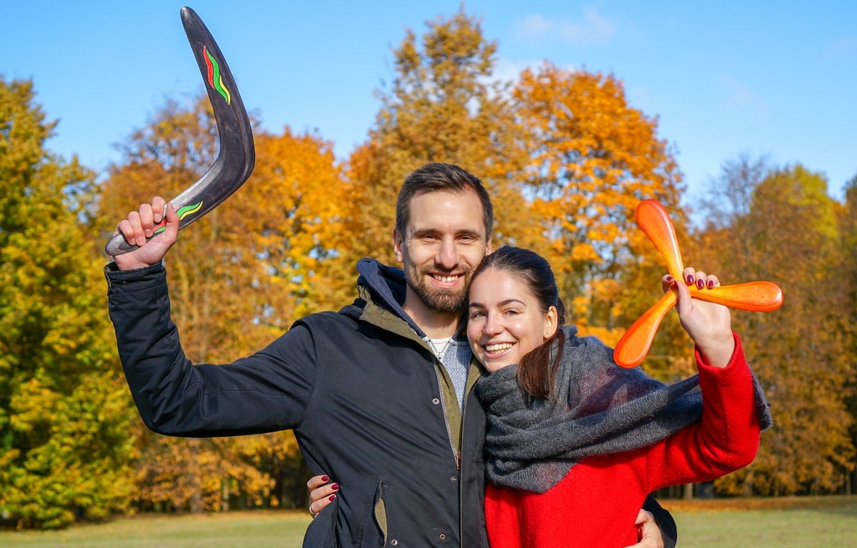 Nemunas Pakalnis, boomerang maker, with handmade wooden boomerangs in an autumn park