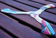 handcrafted-wooden-boomerang-hurricane-quality Hurricane wooden boomerang lying on a dark wooden table showing handcrafted quality.