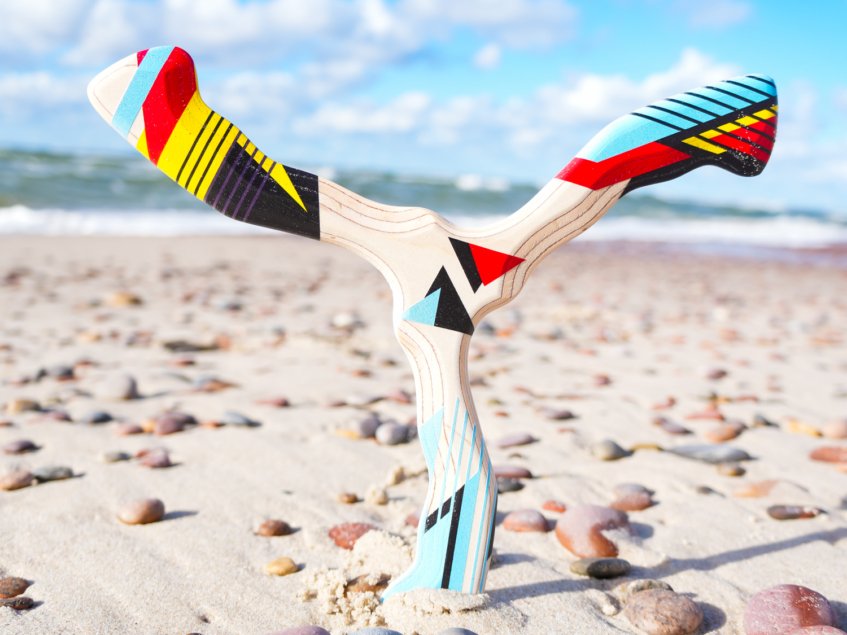 hurricane-boomerang-sand-beach-photography Hurricane tri-blade boomerang standing vertically in beach sand.